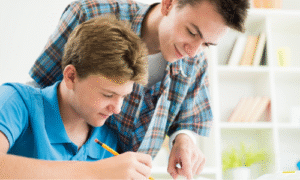 Caring tutor reading with a student, showing why empathy and connection matter when choosing the right tutor for your child.